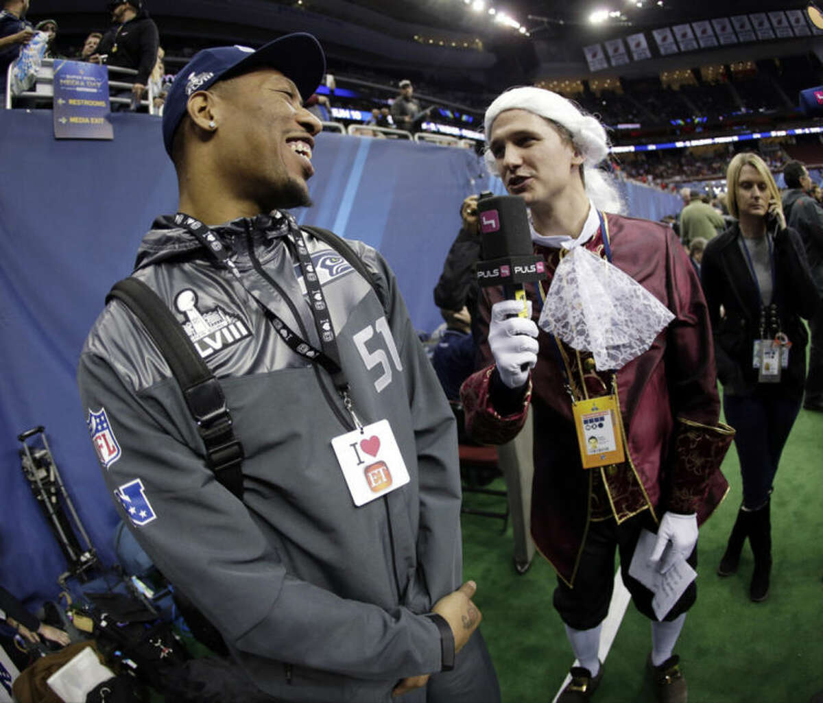 Phillip Hajszan interviews Seattle Seahawks' Bruce Irvin during media day for the NFL Super Bowl XLVIII football game Tuesday, Jan. 28, 2014, in Newark, N.J. (AP Photo/Charlie Riedel)