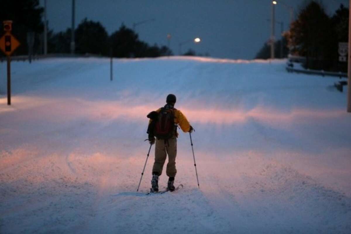 John Fitzgerald, a lineman for Dominion Power, uses cross-country skis on Hanbury Road in Chesapeake, Va. to get to work on Wednesday, Jan. 29, 2014. The National Weather Service says the Norfolk area averages fewer than three days of snow each winter that result in at least an inch of accumulation. Wednesday marks the fourth day in less than two weeks that at least an inch of snow has fallen. (AP Photo/The Virginian-Pilot, Steve Earley)