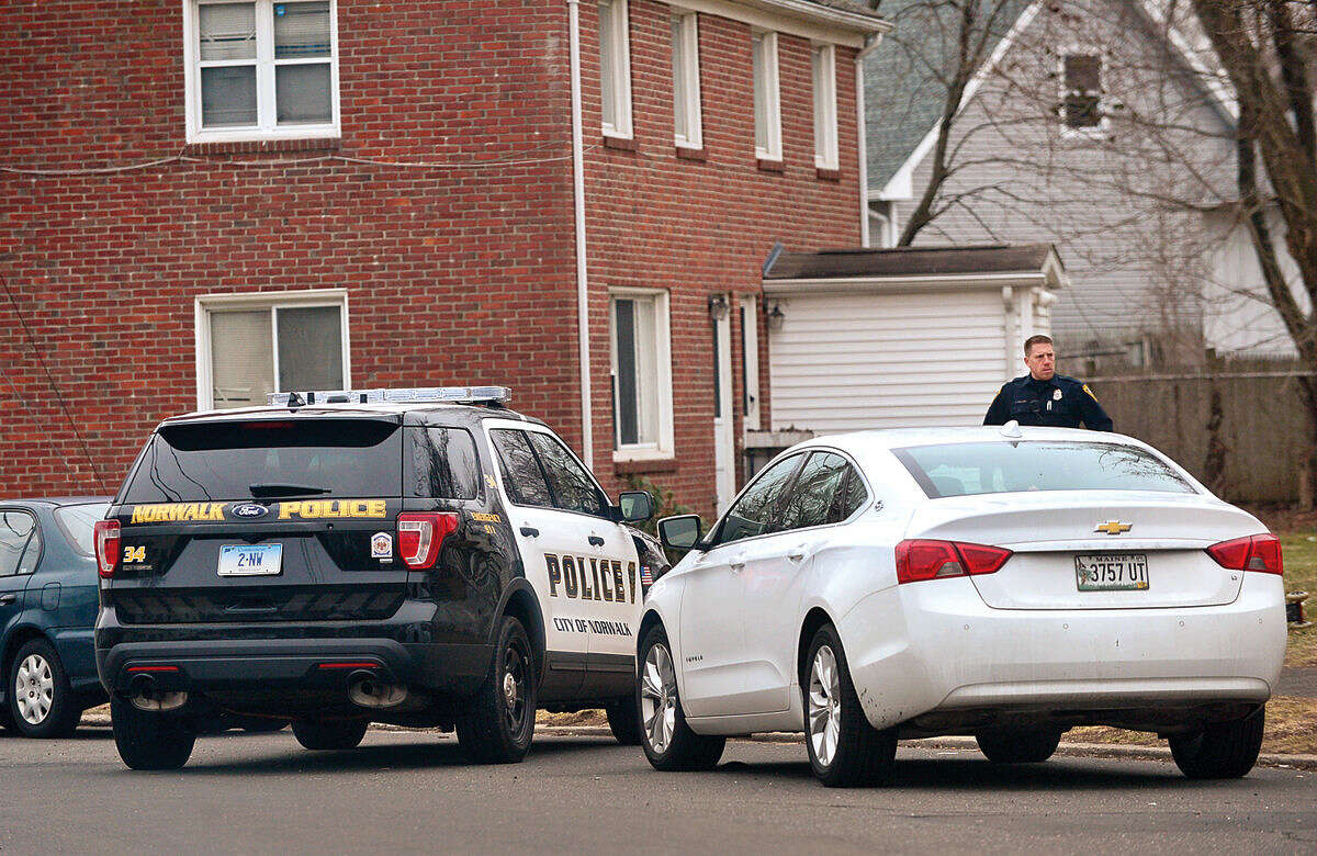 Hour photo / Erik Trautmann Norwalk police search for a suspect at Colonial Village after a stolen motor vehicle was recovered nearby on Tuesday morning.