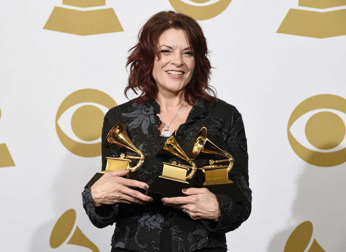 Rosanne Cash poses in the press room with the awards for best American roots performance for “A Feather's Not A Bird”, best American roots song for “A Feather's Not A Bird” and best Americana album for “The River & The Thread” at the 57th annual Grammy Awards at the Staples Center on Sunday, Feb. 8, 2015, in Los Angeles. (Photo by Chris Pizzello/Invision/AP)