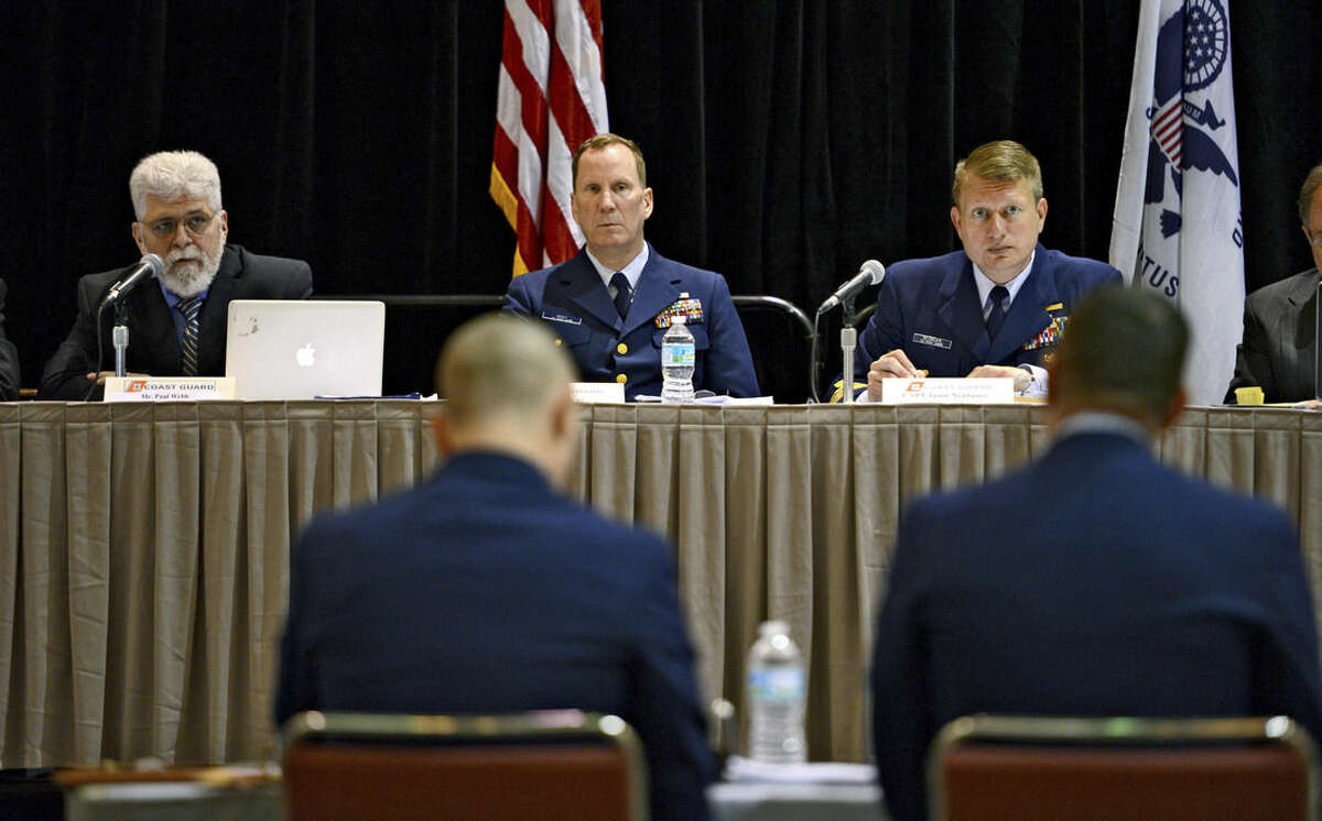 Paul Webb, left, a search and rescue specialist and advisor to the board, asks a question of OS2 Matthew Chancery, foreground right, U.S. Coast Guard District 7, as Cmdr. Jeff Bray, center, Marine Board of Investigation Legal Advisor U.S. Coast Guard, and Capt. Jason Neubauer, right, chair of the marine investigation, listen during a U.S. Coast Guard investigative hearing into the sinking of the El Faro in Jacksonville, Fla., Wednesday, Feb. 24, 2016. The 790-foot-long ship sank Oct. 1 after losing propulsion and getting overwhelmed by high winds from Hurricane Joaquin. (Bob Mack/The Florida Times-Union via AP) MANDATORY CREDIT