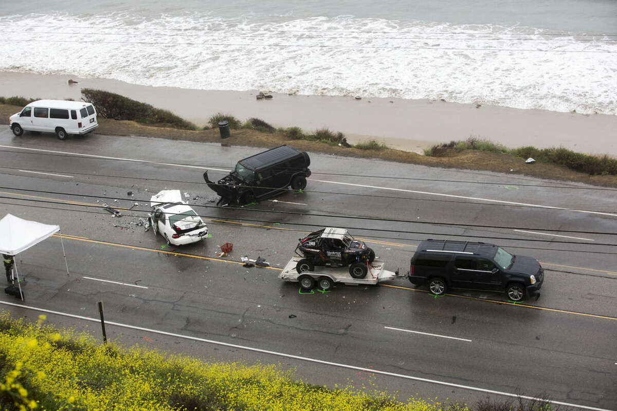 The SUV with a trailer, belonging to Reality-TV star Bruce Jenner, is seen at the scene of a car crash where one person was killed and at least seven other's were injured, Saturday, Feb. 7, 2015. Jenner was in one of the cars involved in the four-vehicle crash on the Pacific Coast Highway in Malibu that killed a woman, Los Angeles County authorities said. (AP Photo/Ringo H.W. Chiu)