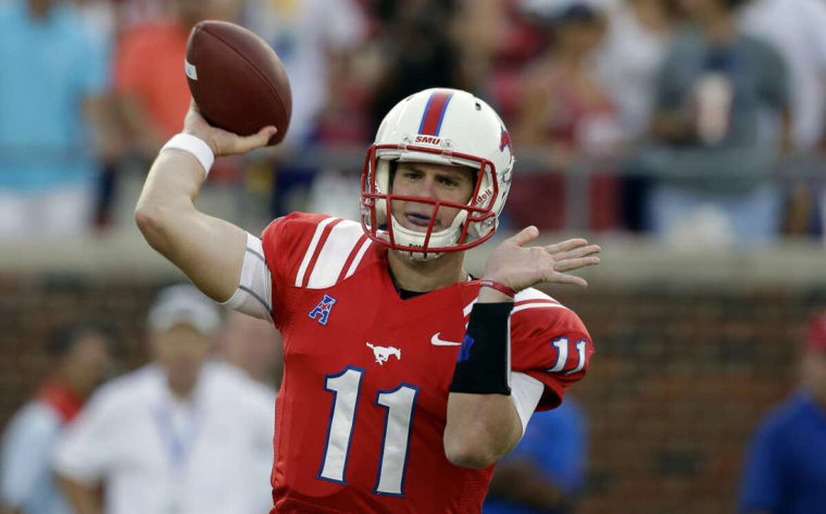 FILE - IN this Aug. 30, 2013, file photo, SMU quarterback Garrett Gilbert throws a pass during the first half of an NCAA college football game against Texas Tech in Dallas. Four months after relaunching his sports agency, Leigh Steinberg has signed Gilbert as his first football client. (AP Photo/LM Otero, File)