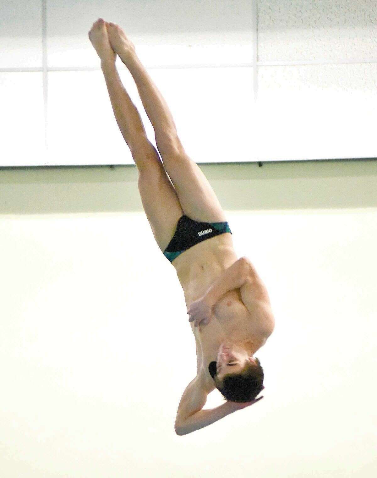 Hour photo/John Nash - Norwalk-McMahon's Kevin Bradley performs one of his 11 dives during Wednesday's FCIAC Diving championship meet at Westhill High School's pool in Stamford.