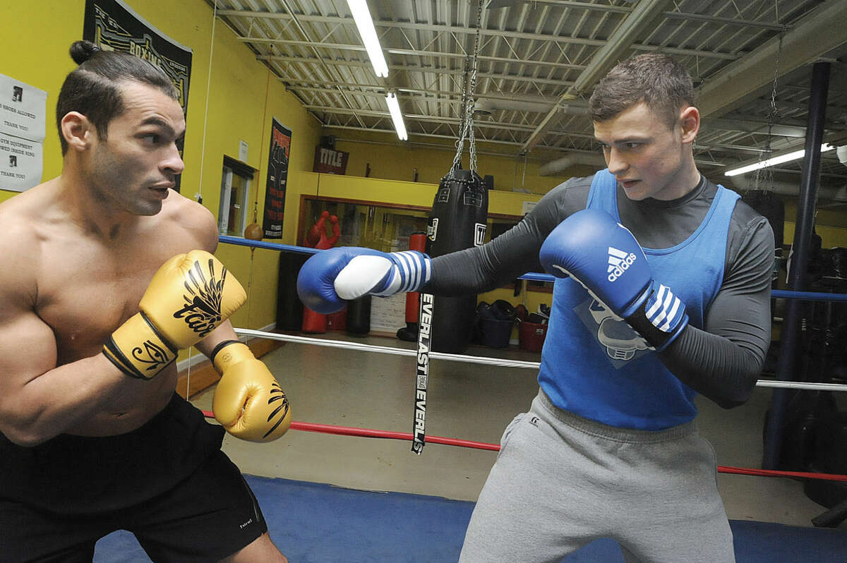 Vinicius De Jesus, left, and Ihor Laba, right, at Heavy Hitting Boxing and Fitness in Stamford. The two, both immigrants, are among the gym’s best boxing prospects.
