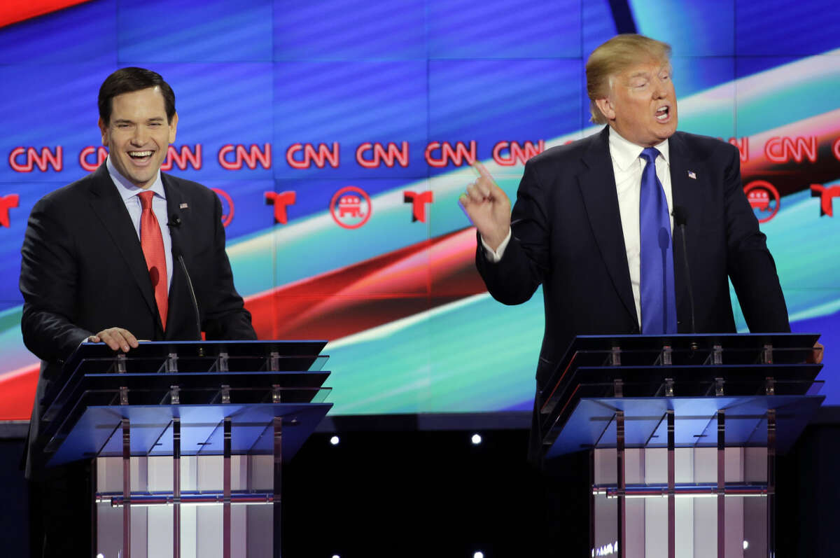Republican presidential candidate, Sen. Marco Rubio, R-Fla., left, reacts as Republican presidential candidate, businessman Donald Trump speaks during a Republican presidential primary debate at The University of Houston, Thursday, Feb. 25, 2016, in Houston. (AP Photo/David J. Phillip)