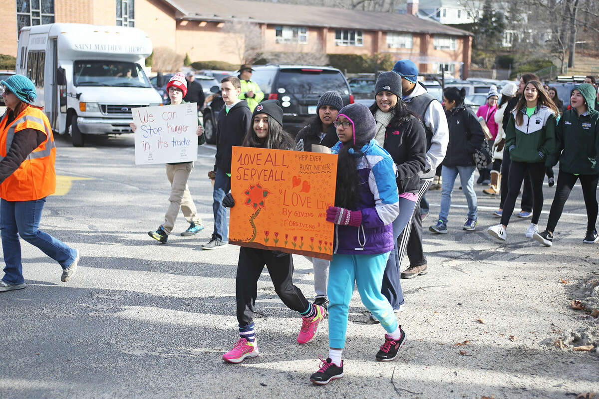 Participants kick off the 30 hour famine to raise world hunger awareness by walking 2.3 miles starting at Saint Jerome’s Church in Norwalk Saturday morning. Hour Photo / Danielle Calloway