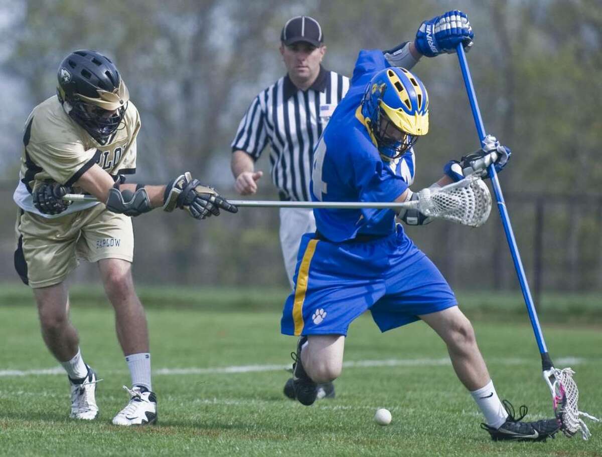 Barlow's Pat Eaker and Brookfield's Seth Kaltrider try to control the loose ball during a boys lacrosse game at Barlow. Wednesday, April 21, 2010