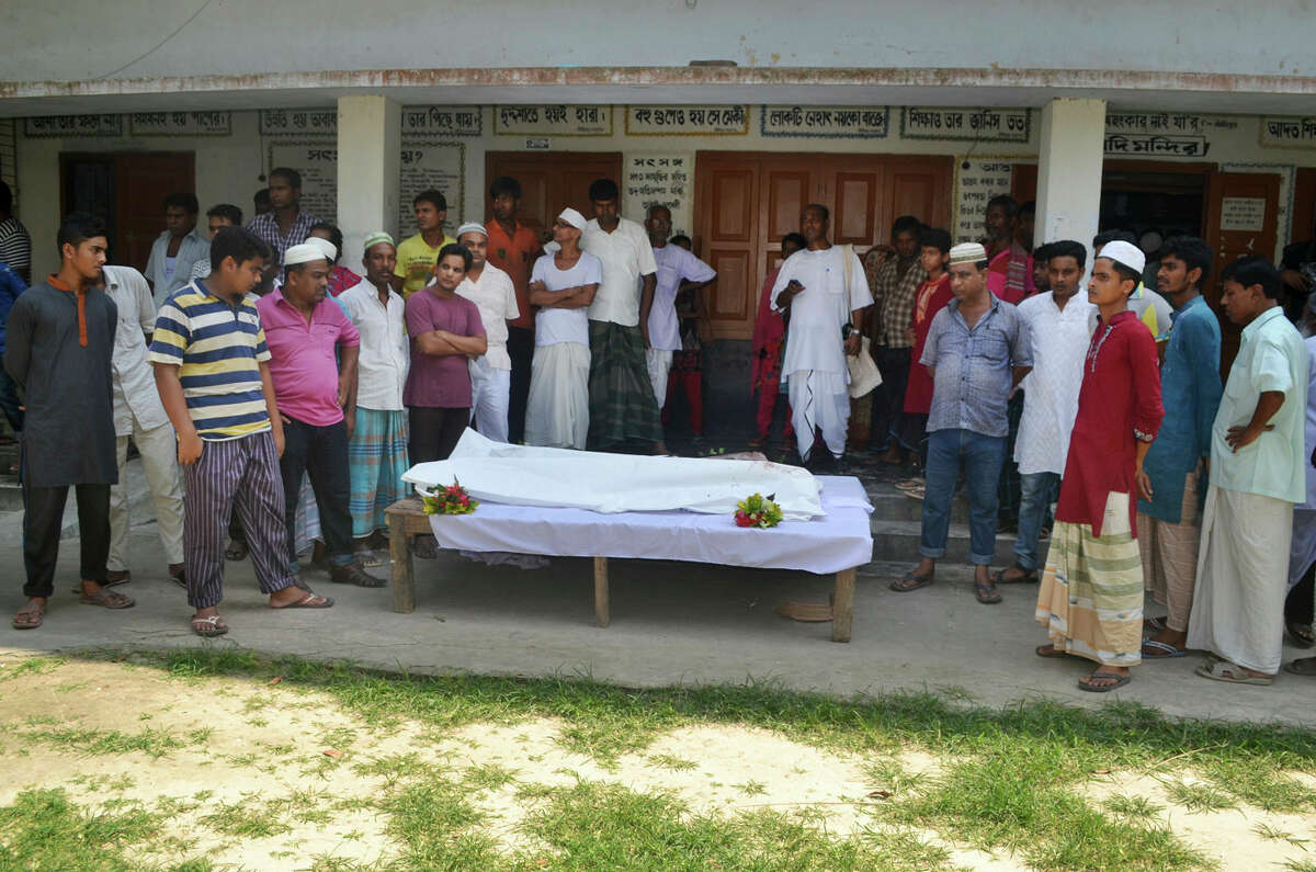Locals surround the body of a Hindu holy man after assailants hacked him to death in Pabna, 275 kilometres (170 miles) from Dhaka, Friday, June 10, 2016. Pabna district police chief Alamgir Kabir said that radical Islamists are suspected of carrying out the attack on 60-year-old Nitya Ranjan Pandey while he was taking a walk at dawn near his ashram. (AP Photo)