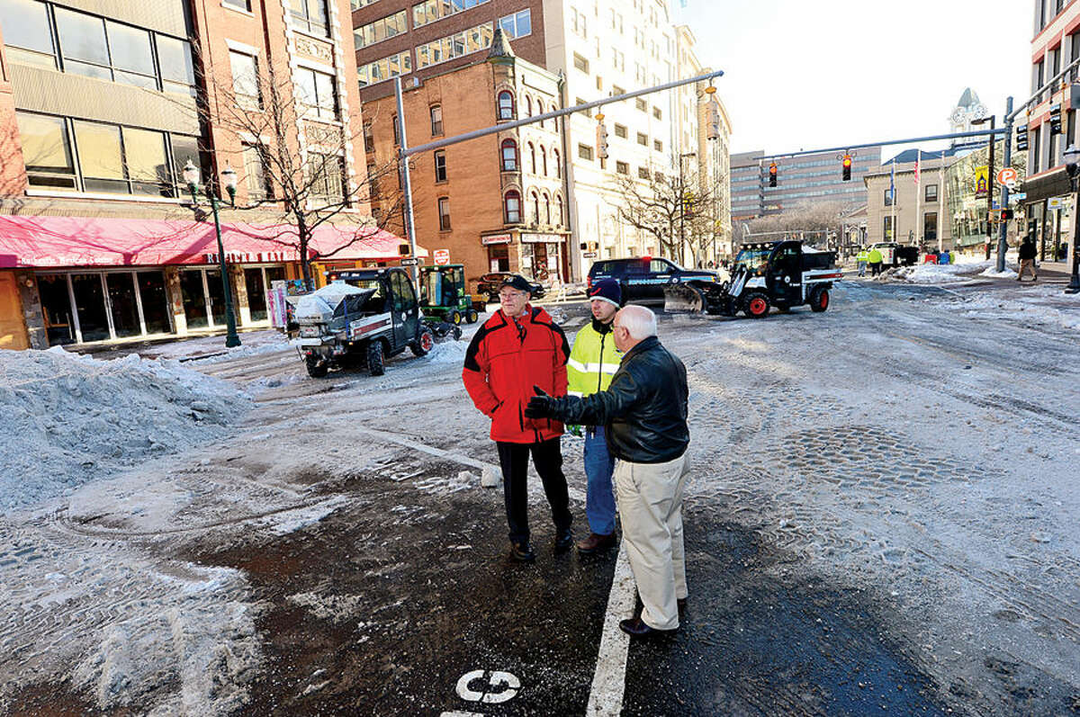 Hour photo / Erik Trautmann Mayor David Martin reviews the City of Stamford Department of Operations snow removal operations in the downtown area Wednesday with Department Director, Ernie Orgera, and Traffic and Road Maintenance Supervisor, Thomas Turk. Affected streets; Main Street between Washington Blvd. and Atlantic Street, West Park Place, Bank Street, Bedford Street between Broad Street and Walton Place were closed while cleaning occurred.