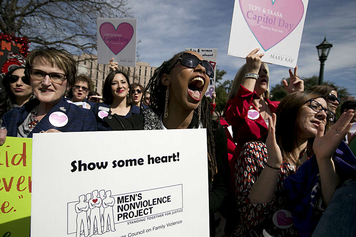 Jamie Allen, a domestic abuse survivor, center, yells in support of a speaker during a rally, Wednesday, Feb. 11, 2015, at the Capitol in Austin, Texas. Victims' rights advocates rallied to call for funding for domestic violence and sexual assault programs across the state. (AP Photo/Austin American-Statesman, Deborah Cannon) AUSTIN CHRONICLE OUT, COMMUNITY IMPACT OUT, INTERNET AND TV MUST CREDIT PHOTOGRAPHER AND STATESMAN.COM, MAGS OUT