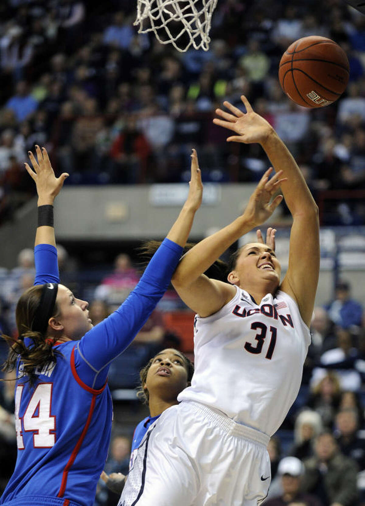 Connecticut's Stefanie Dolson (31) drives past SMU's Mallory Singleton (44) during the first half of an NCAA college basketball game in Storrs, Conn., Tuesday, Feb. 4, 2014. (AP Photo/Fred Beckham)