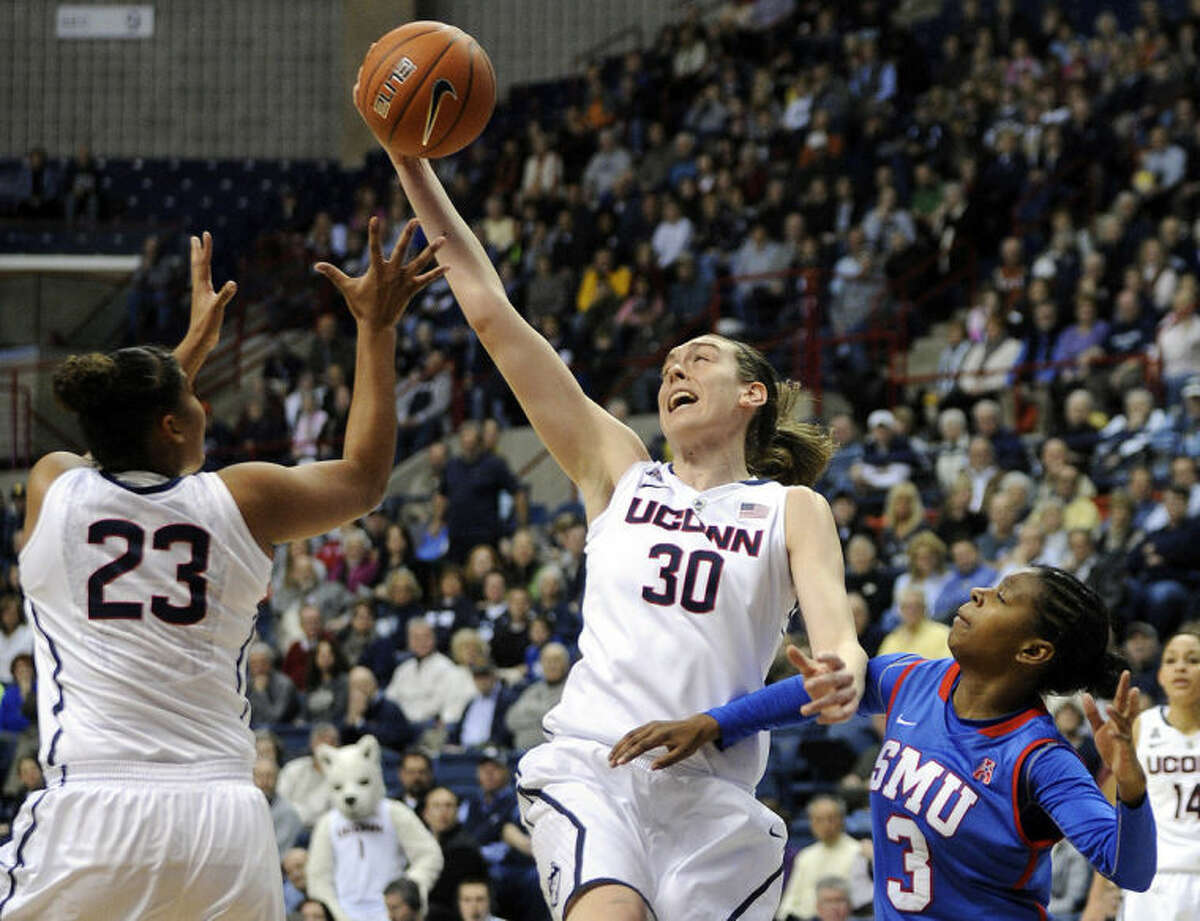 Connecticut's Breanna Stewart (30) grabs a rebound as teammate Kaleena Mosqueda-Lewis (23) and SMU's Gabrielle Wilkins (3) look on during the first half of an NCAA college basketball game in Storrs, Conn., Tuesday, Feb. 4, 2014. (AP Photo/Fred Beckham)