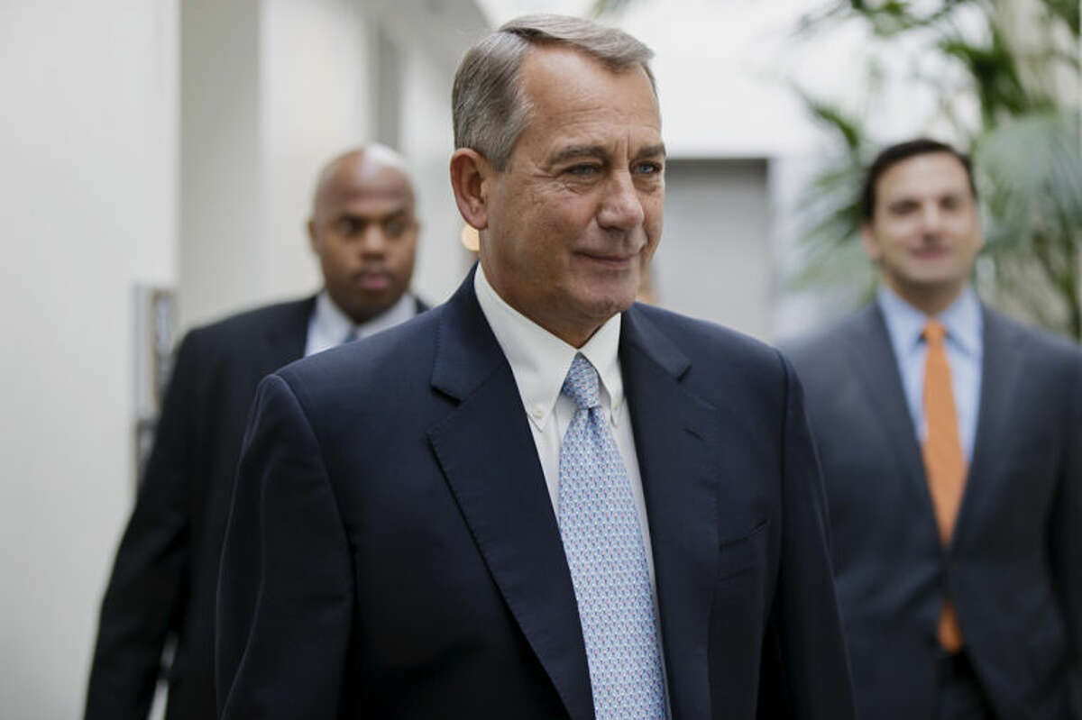 House Speaker John Boehner of Ohio smiles as walks to a strategy meeting with fellow Republicans before speaking to reporters about the Keystone XL Pipeline and other issues, Tuesday, Feb. 4, 2014, on Capitol Hill in Washington. (AP Photo/J. Scott Applewhite)