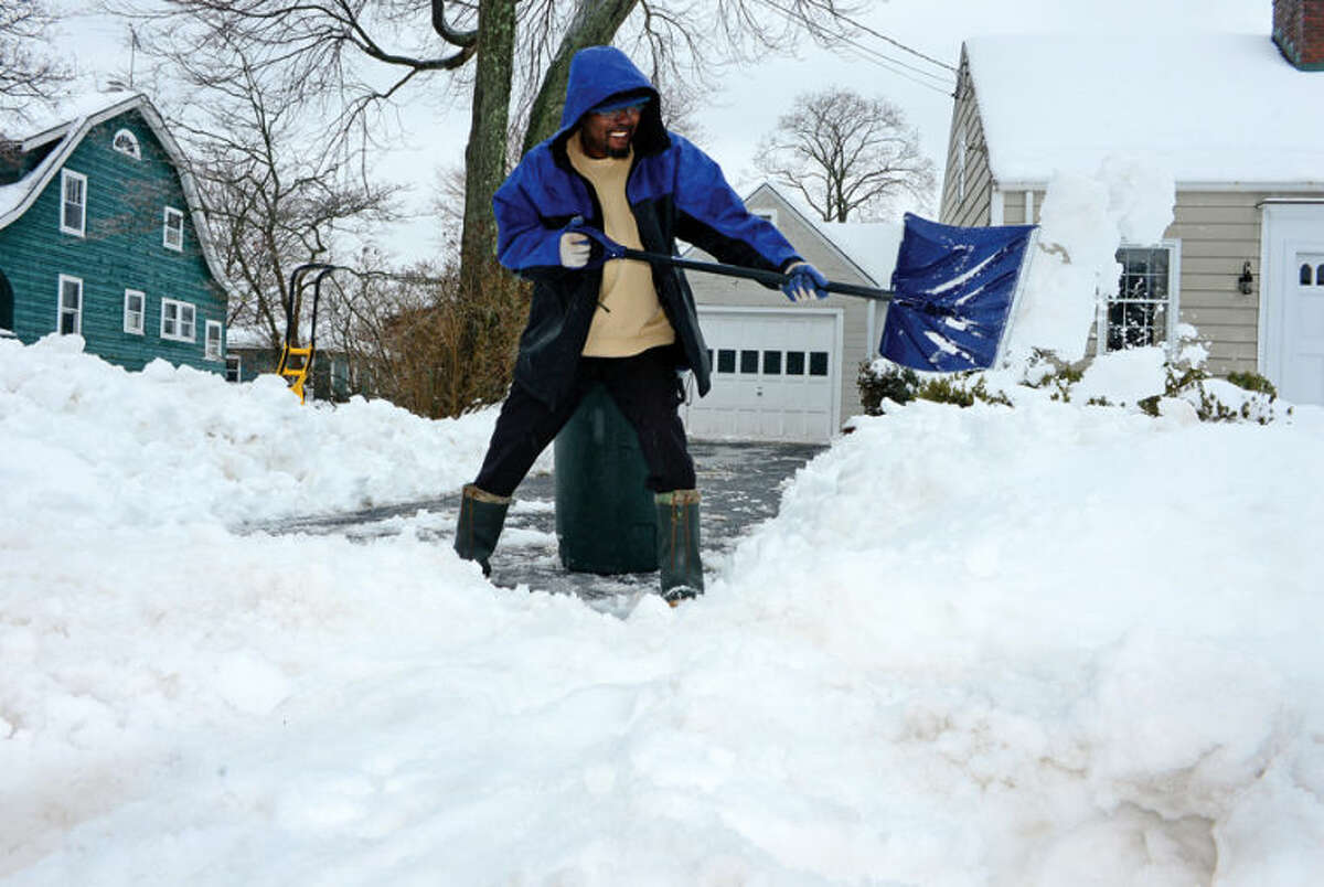 Hour photo / Erik Trautmann Garnett Salkie shivels snow in front of his home on Gregory Blvd following the recent winter storm that left 5 inches of wet snow Wednesday morning.