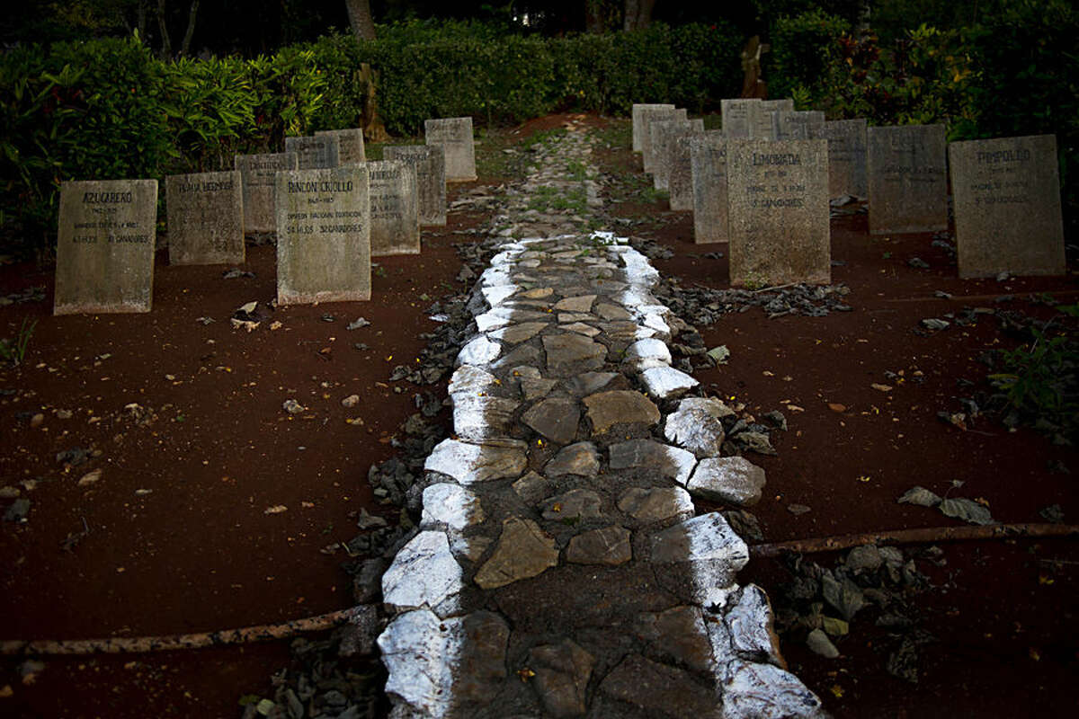 In this Feb. 4, 2015 photo, tombstones of the first stallions at the state-run Azucarero horse ranch, where an artificial insemination program is being developed, stand in a horse cemetery at the ranch in Artemisa, Cuba. The tombstones carry the horses' names, birthdays, the years they died, their number of offspring as well as how many of their offspring were winners. Some of the names on the tombstones are Azucarero, Rincon Criollo, Playa Hermosa, Discutido, Limonada and Pimpollo. (AP Photo/Ramon Espinosa)