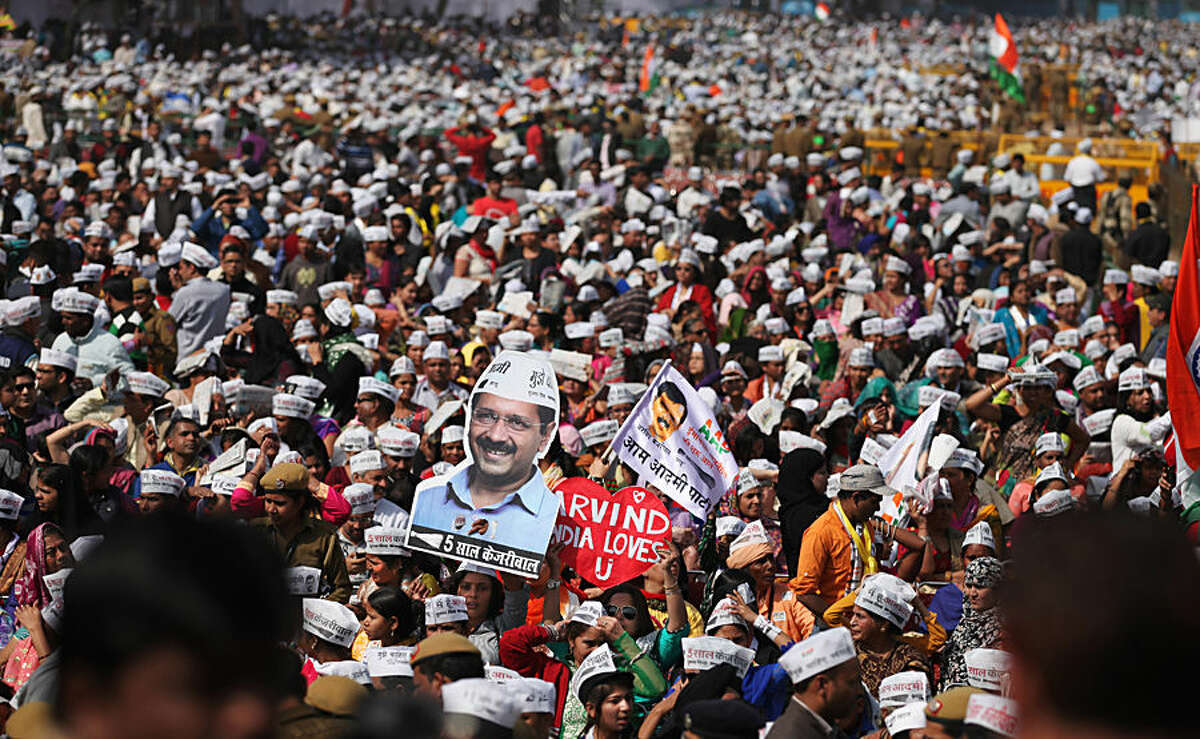 Supporters of Aam Aadmi Party, or Common Man's Party, gather to witness the swearing-in ceremony of party leader Arvind Kejriwal as chief minister of Delhi in New Delhi, India, Saturday, Feb. 14, 2015. The AAP, headed by the former tax official who had remade himself into a champion for clean government, won 67 of the 70 seats in recent elections. Kejriwal and the party he created routed the country's best-funded and best-organized political machine and dealt an embarrassing blow to Prime Minister Narendra Modi. (AP Photo/Altaf Qadri)