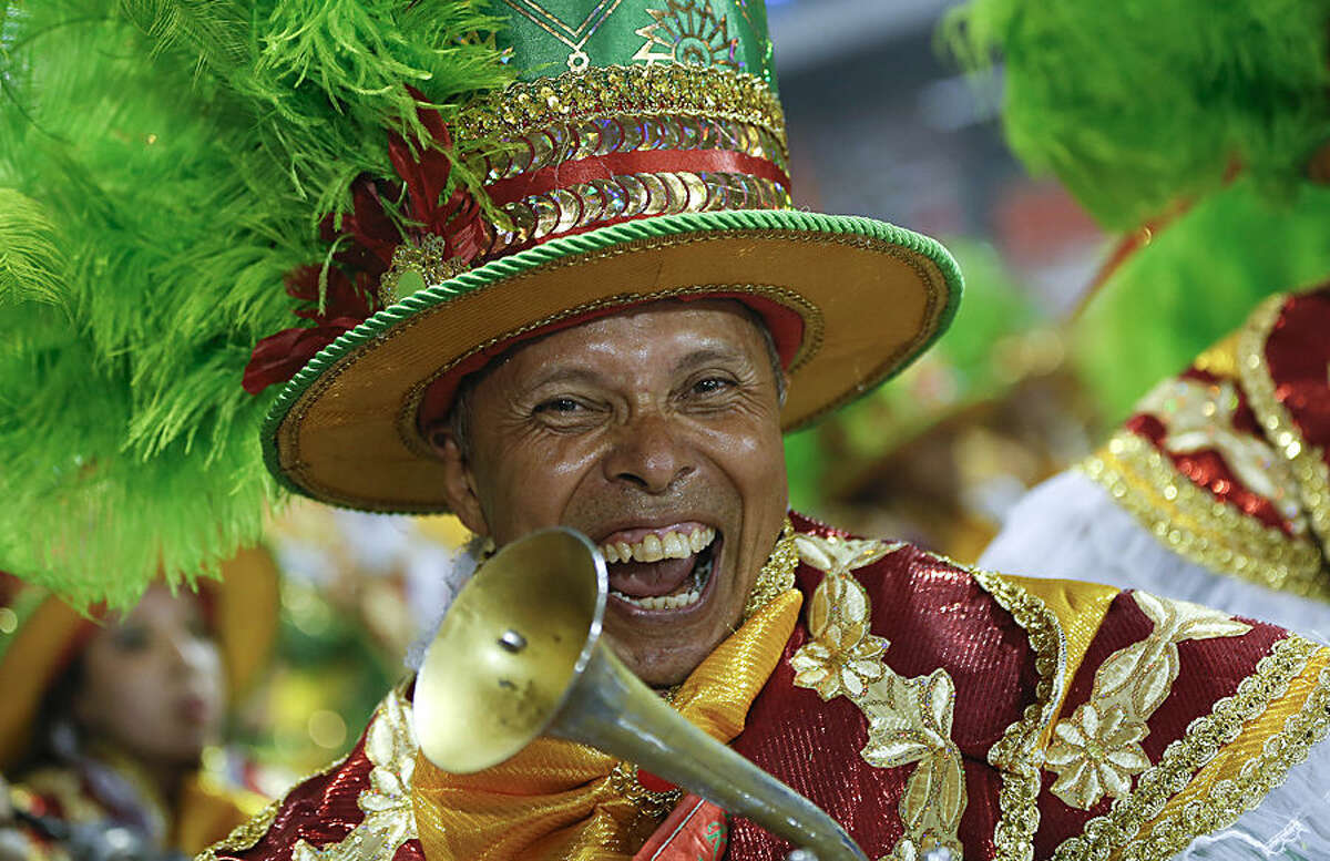 A musician from the Academicos do Tucuruvi samba school performs during the Carnival parade at the Sambodromo in Sao Paulo, Brazil, Friday, Feb. 13, 2015. (AP Photo/Andre Penner)