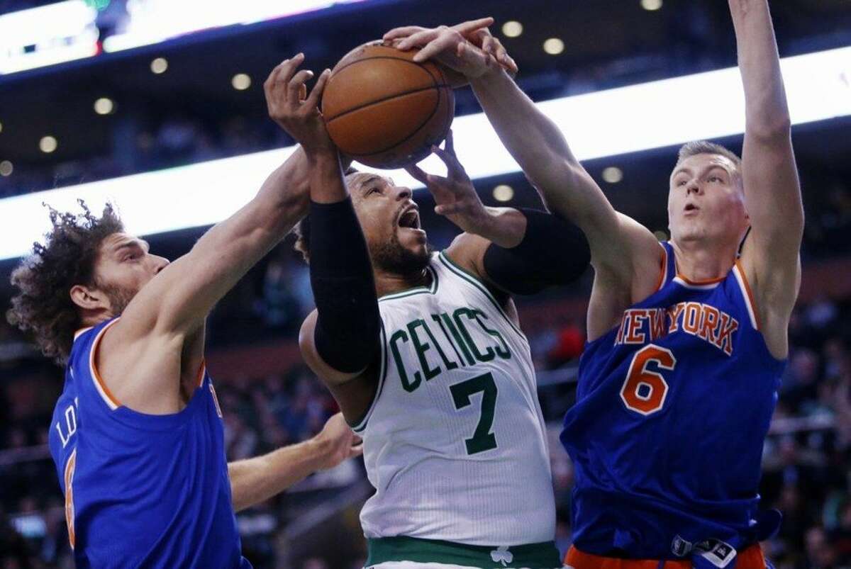 New York Knicks' Kristaps Porzingis (6) blocks a shot by Boston Celtics' Jared Sullinger (7) during the first quarter of an NBA basketball game in Boston, Friday, March 4, 2016. (AP Photo/Michael Dwyer)