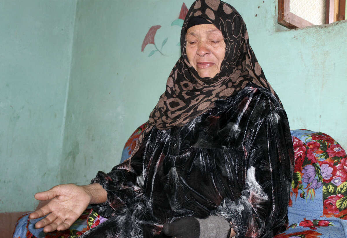 In this Feb. 16, 2016 photo, Um Muhammed speaks about the death of her son, Mohammed Hamdan, at the family house in Beni Suleiman village, south of Cairo, Egypt. The 32-year-old Egyptian government engineer disappeared in mid-January when, according to witnesses, masked police burst into his office in the southern city of Beni Suef and dragged him off in handcuffs in front of his co-workers. (AP Photo/Maggie Michael)