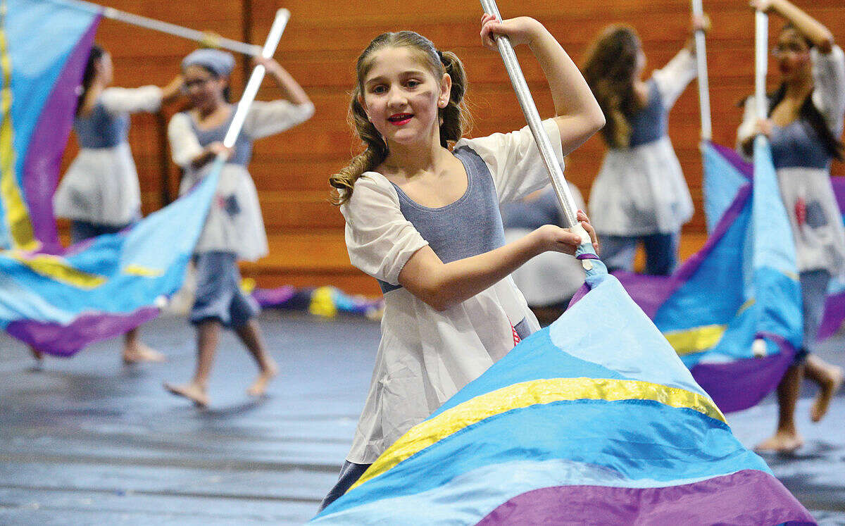 Hour photo / Erik Trautmann Lisa Goodchild performs The Hard Knock Life with the Norwalk Scholastic AAA Winter Guard at the Musical Arts Conference for Winter Guard and Percussion saturday at Norwalk High School.