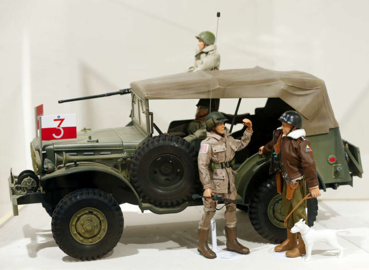 This Jan. 31, 2014 photo shows a Gen. George Patton G.I. Joe action figure, right, and other G.I. Joes in a display at the New York State Military Museum in Saratoga Springs, N.Y. A half-century after the 12-inch doll was introduced at a New York City toy fair, the iconic action figure is being celebrated by collectors with a display at the military museum, while the toy's maker plans other anniversary events to be announced later this month. (AP Photo/Mike Groll)