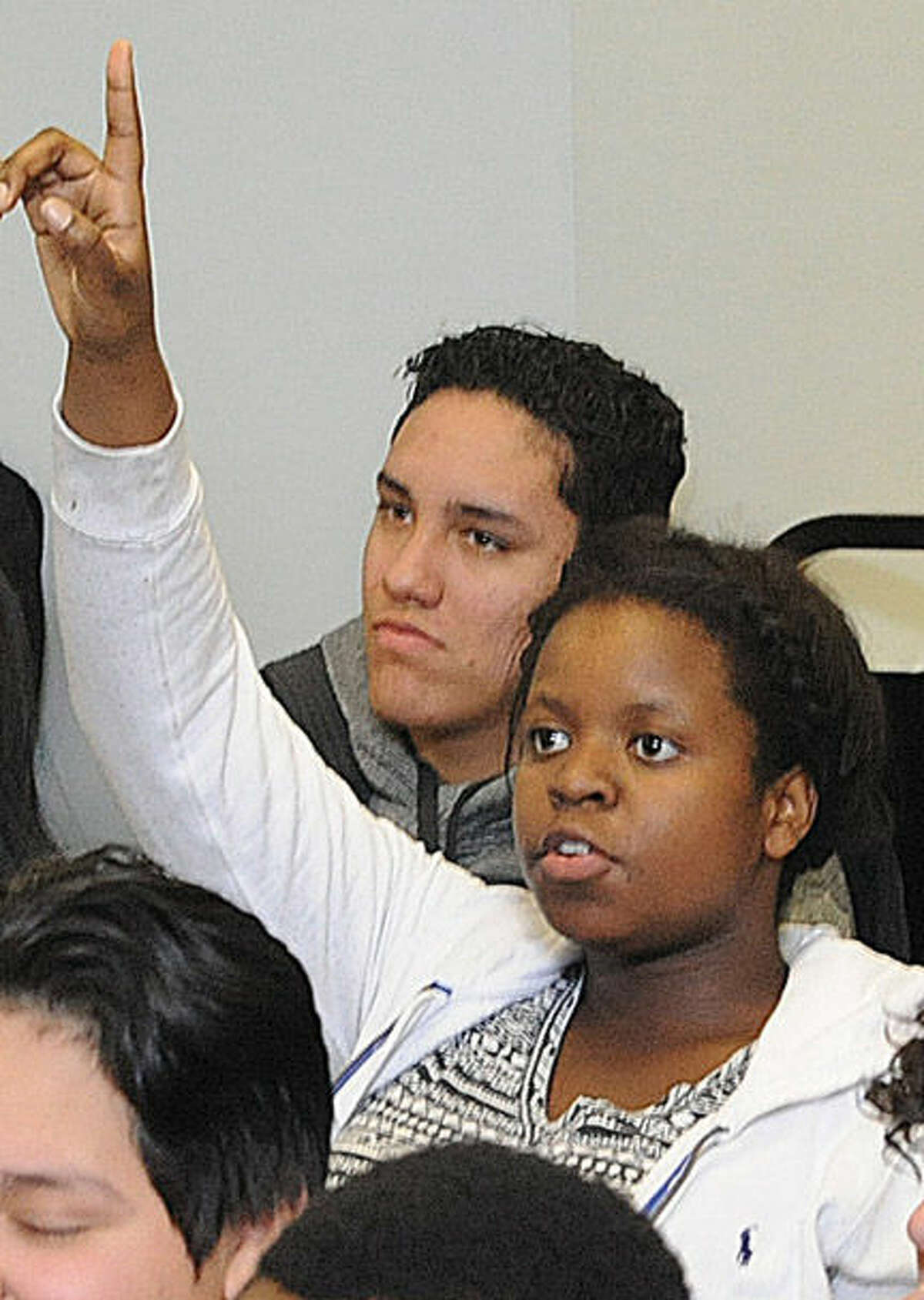 Nahomie Eugene, 15, asks a question Monday at the Stamford YMCA, where police hosted a seminar that walked youths through a number of scenarios that could occur in encounters with officers.