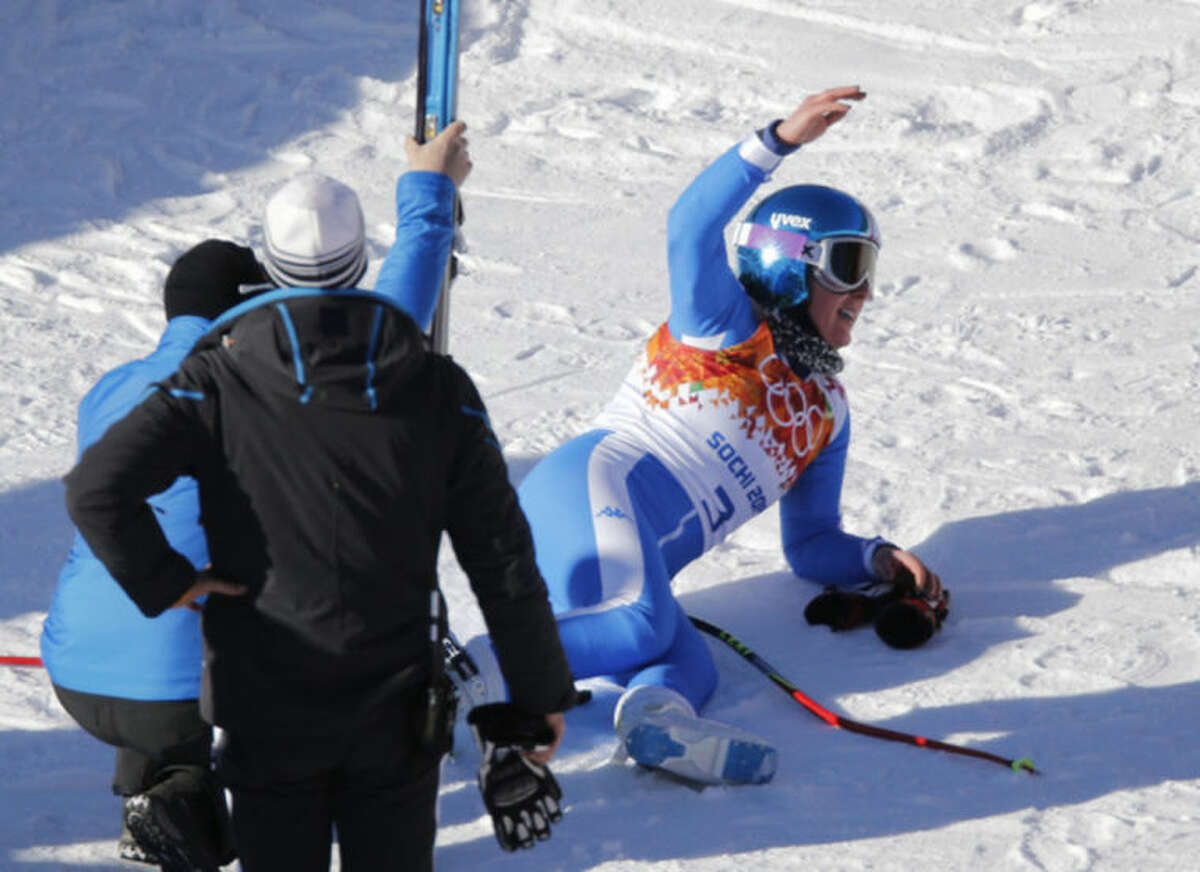 Italy's Daniela Merighetti lies on the snow after finishing a women's downhill training run at the Sochi 2014 Winter Olympics, Thursday, Feb. 6, 2014, in Krasnaya Polyana, Russia. (AP Photo/Christophe Ena)