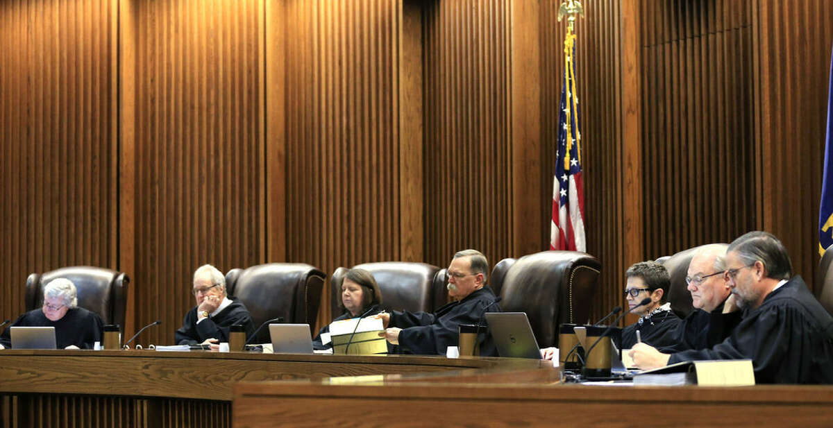 FILE - In this Monday, Dec. 14, 2015 file photo, Kansas Supreme Court Justices prepare to hear arguments in a capital murder case during a session in Topeka, Kan. Republican lawmakers in Kansas are beginning to act on a measure to expand the legal grounds for impeaching judges. The move is part of an intensified effort in red states to reshape courts still dominated by moderate judges from earlier administrations. (AP Photo/Orlin Wagner, File)
