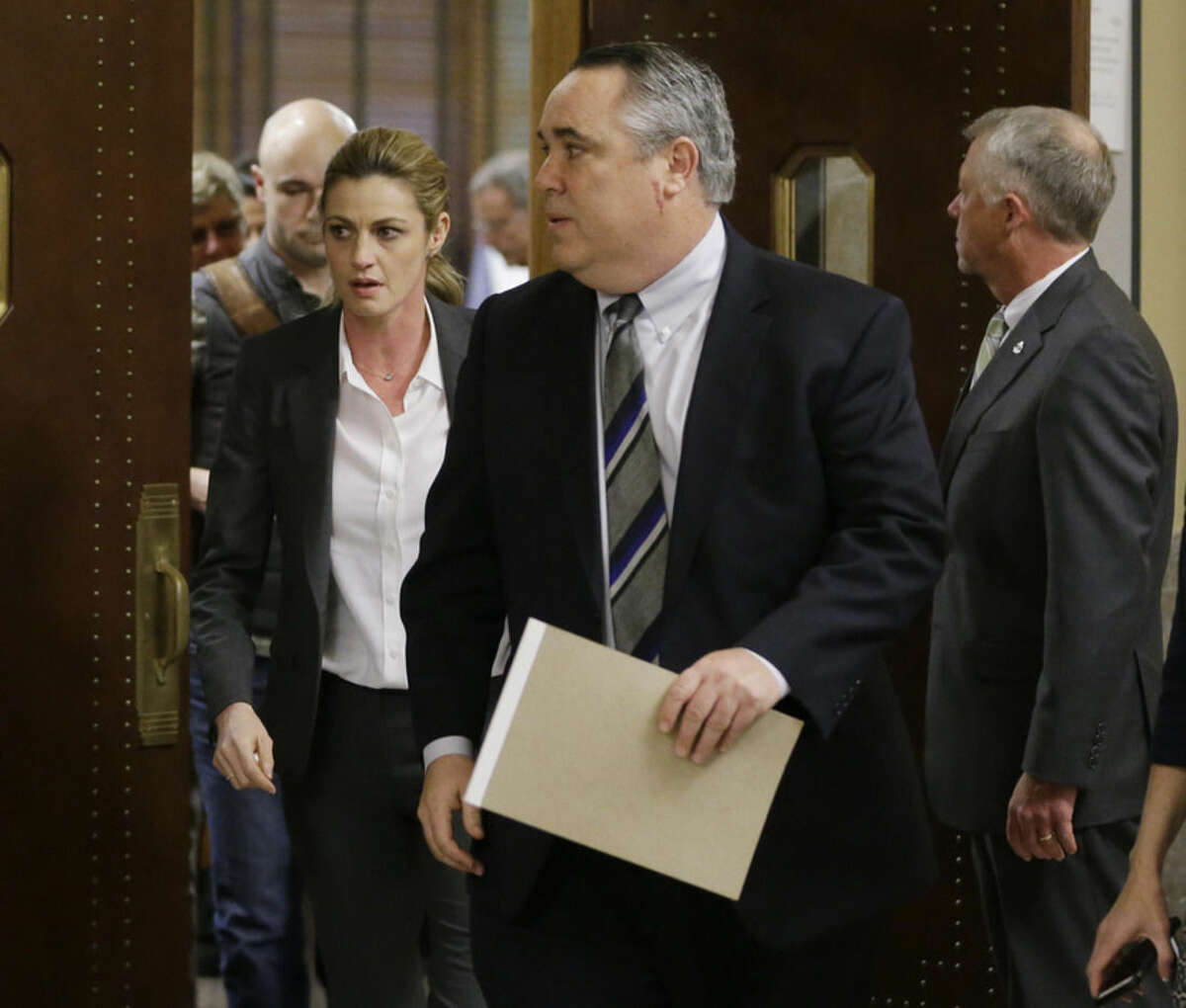 Sportscaster and television host Erin Andrews, left, leaves the courtroom with attorney Scott Carr, center, after the verdict was read in her lawsuit Monday, March 7, 2016, in Nashville, Tenn. A jury has awarded Andrews $55 million in her lawsuit against a stalker who bought a hotel room next to her and secretly recorded a nude video, finding that the hotel companies and the stalker shared in the blame. (AP Photo/Mark Humphrey)
