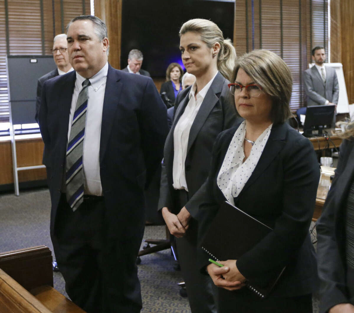 Sportscaster and television host Erin Andrews, center, stands with attorney Scott Carr, left, as the jury enters the courtroom Monday, March 7, 2016, in Nashville, Tenn. Andrews' $75 million lawsuit against the franchise owner and manager of a luxury hotel and a man who admitted to making secret nude recordings of her in 2008 was turned over to the jury Monday. (AP Photo/Mark Humphrey, Pool)