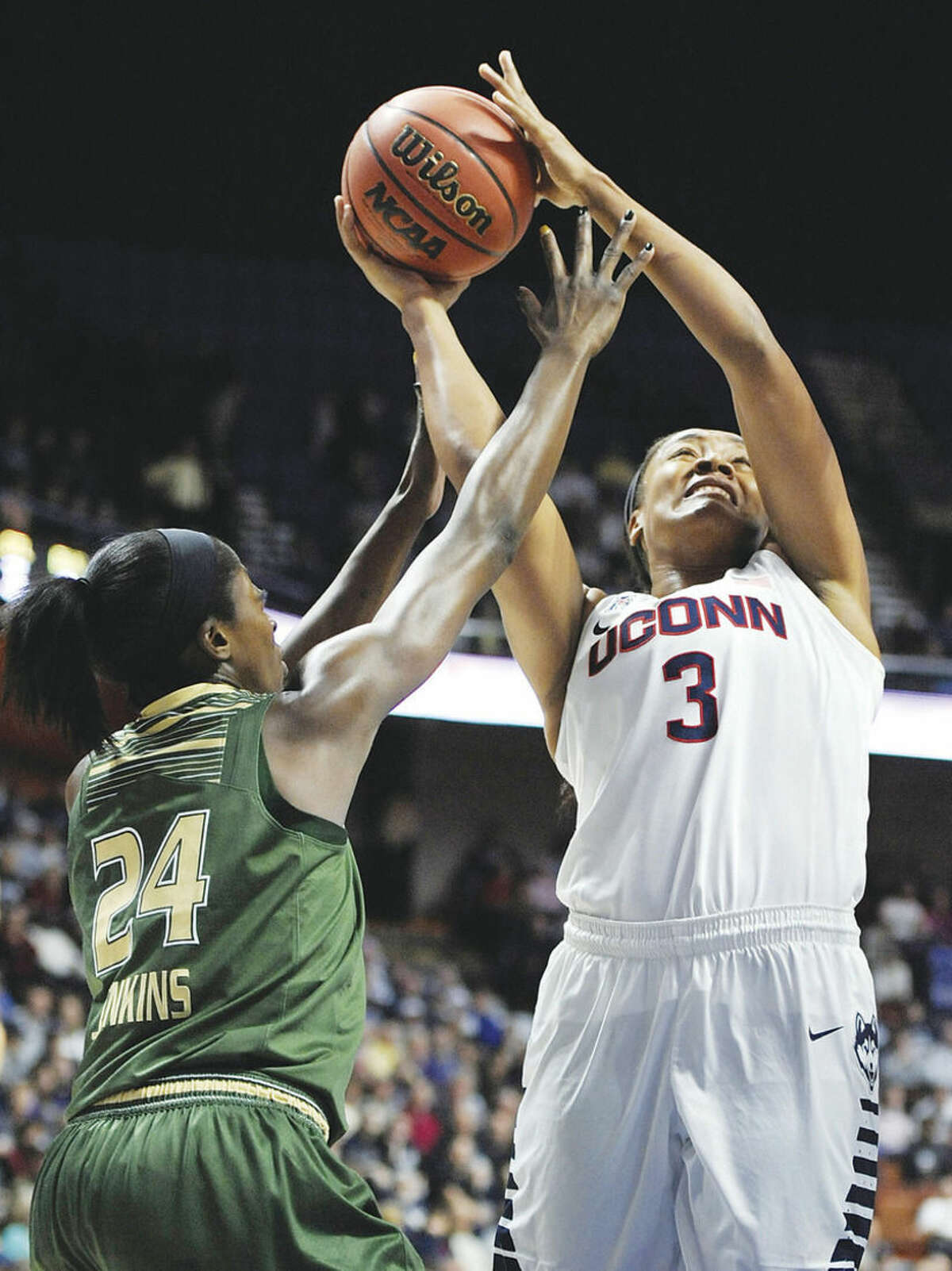 AP photo UConn's Morgan Tuck shoots as South Florida's Alisia Jenkins defends during the first half of Monday's championship game in the American Athletic Conference tournament at Mohegan Sun Arena in Uncasville.