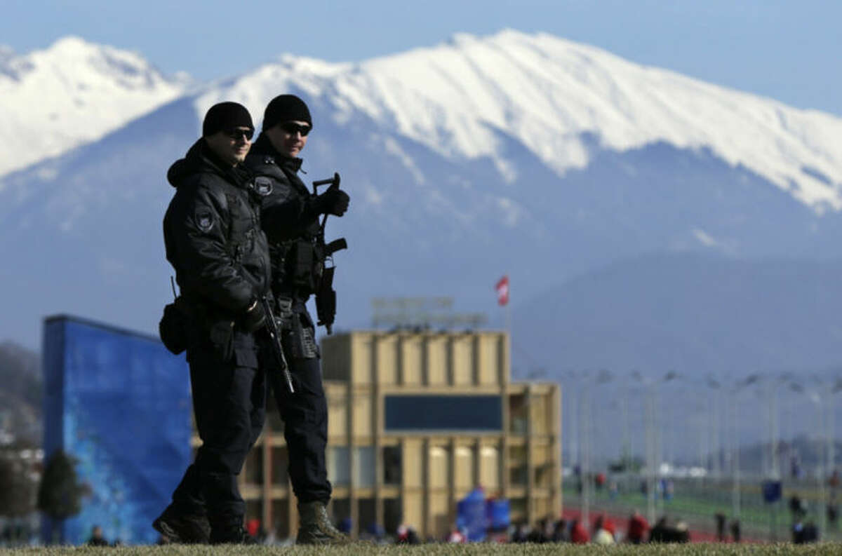Heavily-armed Russian military flash a "thumbs up" while patrolling Olympic Park prior to opening ceremony at the 2014 Winter Olympics, Friday, Feb. 7, 2014, in Sochi, Russia. (AP Photo/Robert F. Bukaty)