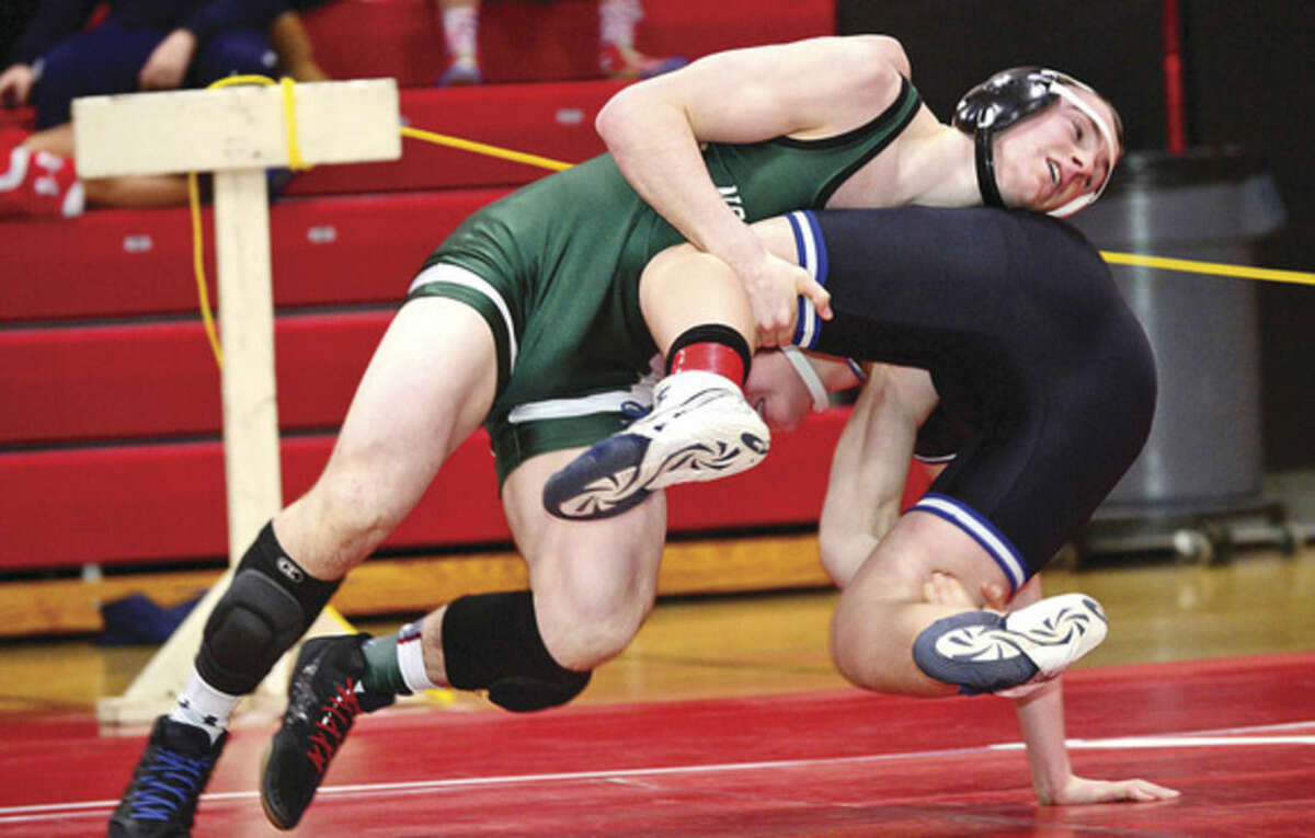Hour photos/Erik Trautmann Above, Connor Halloran of Norwalk puts his opponent to the mat during his 160-pound wrestle-back match at Saturday's FCIAC championship meet in New Canaan. Halloran placed fifth in his weight class. At right, Wilton's Finn McGovern, bottom, got out of this precarious situation to defeat Zach Taylow of Ludlowe in their 99-pound weight class semifinal match.
