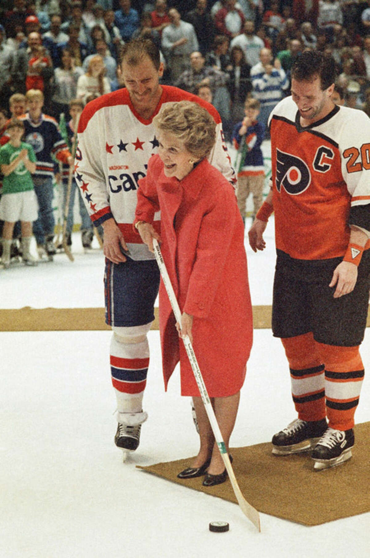 FILE - In this March 25, 1988 file photo, then first lady Nancy Reagan kicks off the NHL's "Just Say No" campaign to help overcome drug abuse among young people, with the help of Washington Capitals captain Red Langway and Philadelphia Fliers captain Dave Poulin, before a hockey game in Landover, Md. Reagan, who died Sunday, March 6, 2016, is perhaps best known for her "Just Say No" to drugs and alcohol campaign. Three decades after the campaign's heyday, prevention experts credit it with spawning a new generation of research into the best ways of reducing drug abuse. But they also say that many of the fear-based tactics it embraced didn't work.(AP Photo/C.W. Agel II, File)