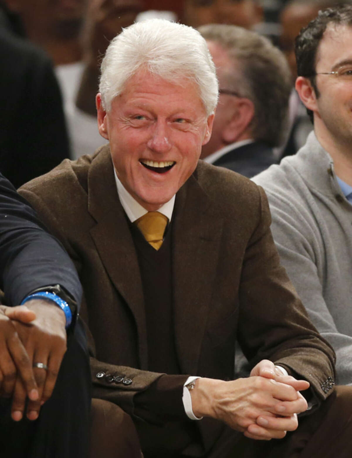 Former President Bill Clinton watches the first half of the NBA All-Star basketball game, Sunday, Feb. 15, 2015, in New York. (AP Photo/Kathy Willens)