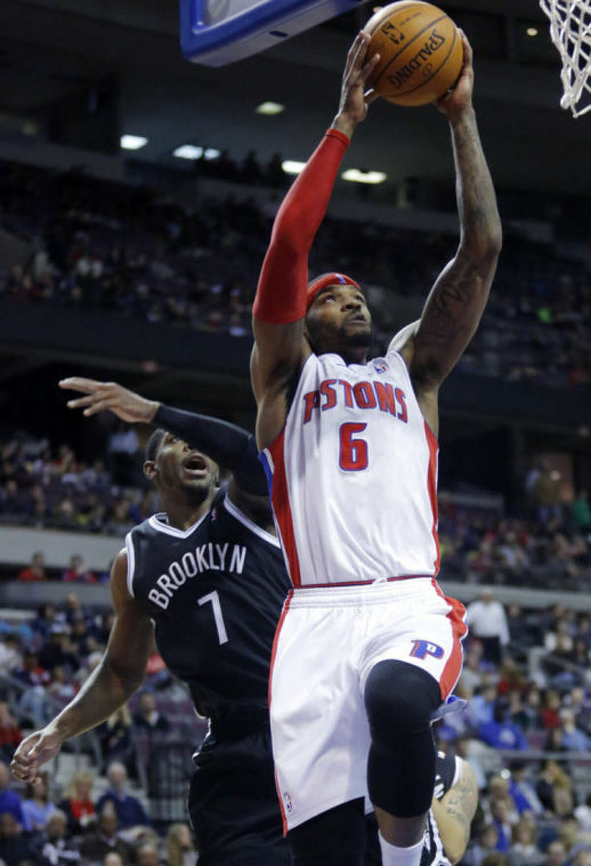Detroit Pistons forward Josh Smith (6) gets past Brooklyn Nets guard Joe Johnson (7) for a dunk during the first half of an NBA basketball game on Friday, Feb. 7, 2014, in Auburn Hills, Mich. (AP Photo/Duane Burleson)