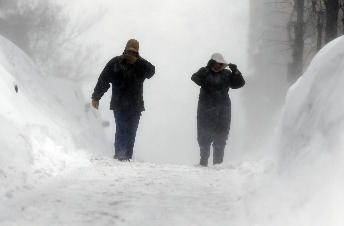 Lynn Cullins, right, and Kevin Burit, both of Caribou, Maine, walk through blowing snow on Beacon Hill in Boston, Sunday, Feb. 15, 2015. A blizzard warning was in effect for coastal communities from Rhode Island to Maine, promising heavy snow and powerful winds to heap more misery on a region that has already seen more than 6 feet of snow in some areas. (AP Photo/Michael Dwyer)