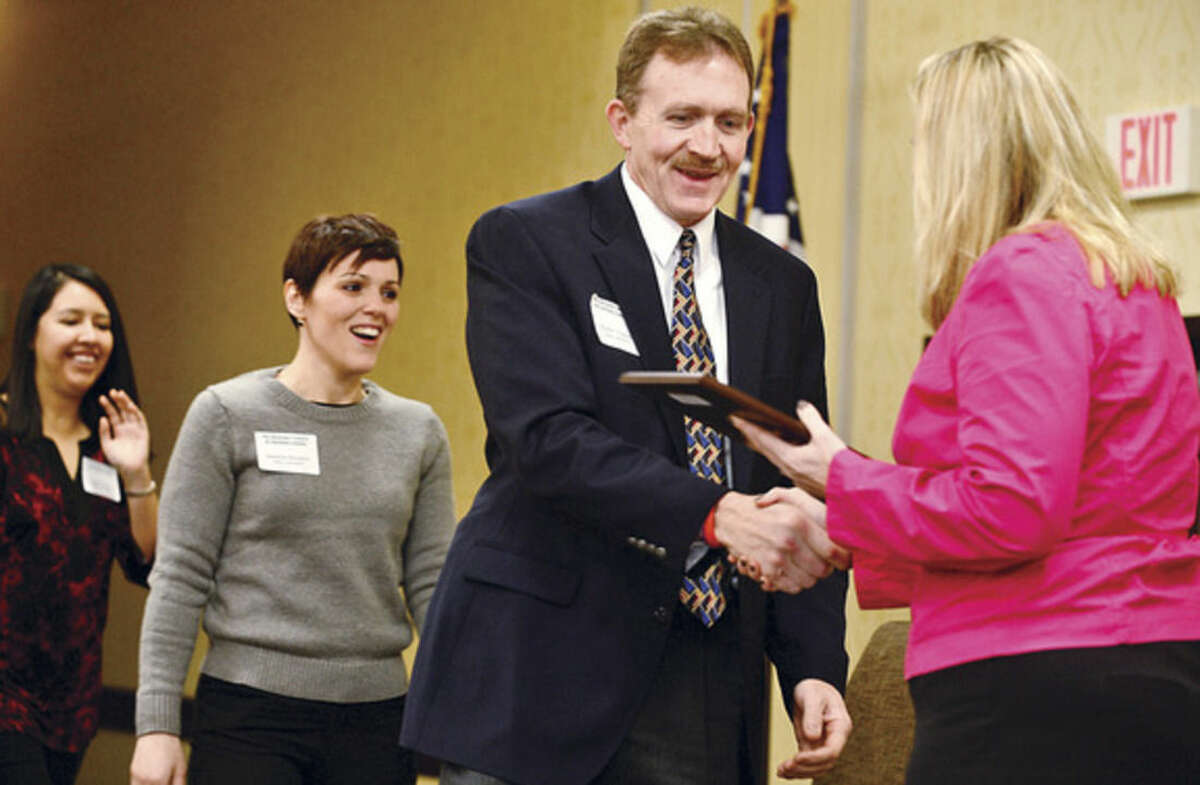 Hour photo / Erik Trautmann Walter Watson accepts the Platinum Business Council of Fairfield County Healthy Workplace Employer Recognition Award Friday morning at the Sheraton Stamford Hotel.