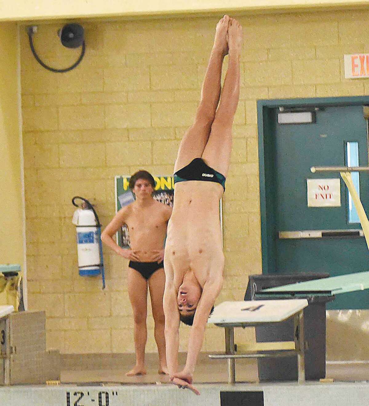 Hour photo/John Nash - Norwalk-McMahon co-op freshman diver Kevin Bradley prepares to enter the water during one of his 11 dives at Wednesday's CIAC Class LL diving championship meet at Hamden High School.