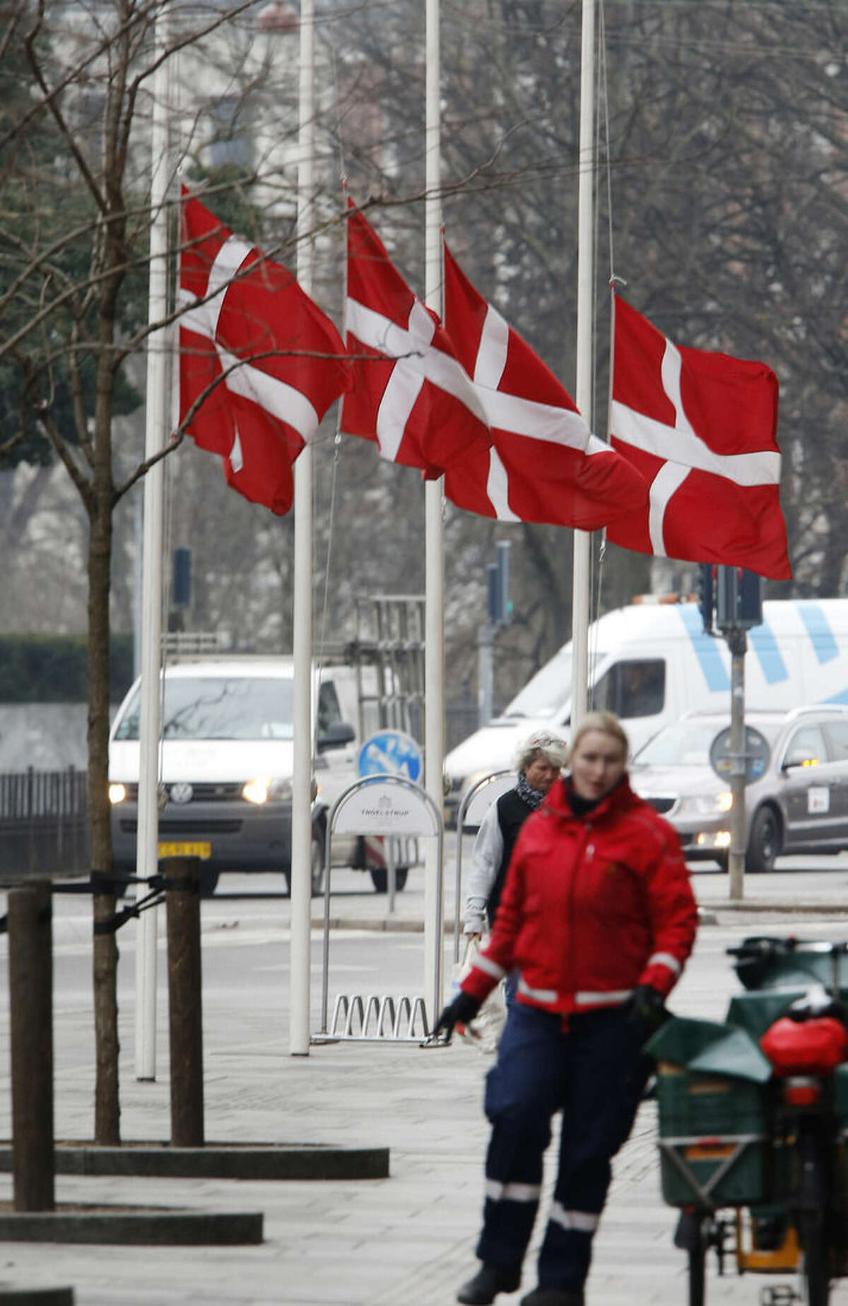 Danish flags are on half-mast in Copenhagen, Denmark, Monday, Feb. 16, 2015 after an alleged shooter killed two persons. Danish police shot and killed the man early Sunday suspected of carrying out shooting attacks at a free speech event and then at a Copenhagen synagogue, killing a Danish documentary filmmaker and a member of the Scandinavian country's Jewish community. (AP Photo/Michael Probst)
