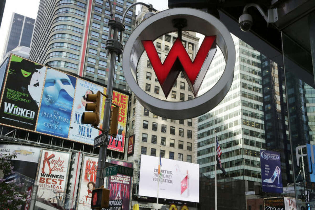 FILE - In this Wednesday, July 31, 2013, file photo, a W Hotel is located in Times Square, in New York. The luxury hotel is owned by Starwood Hotels & Resorts Worldwide, who reports earnings on Thursday, Feb. 13, 2014. (AP Photo/Mark Lennihan)