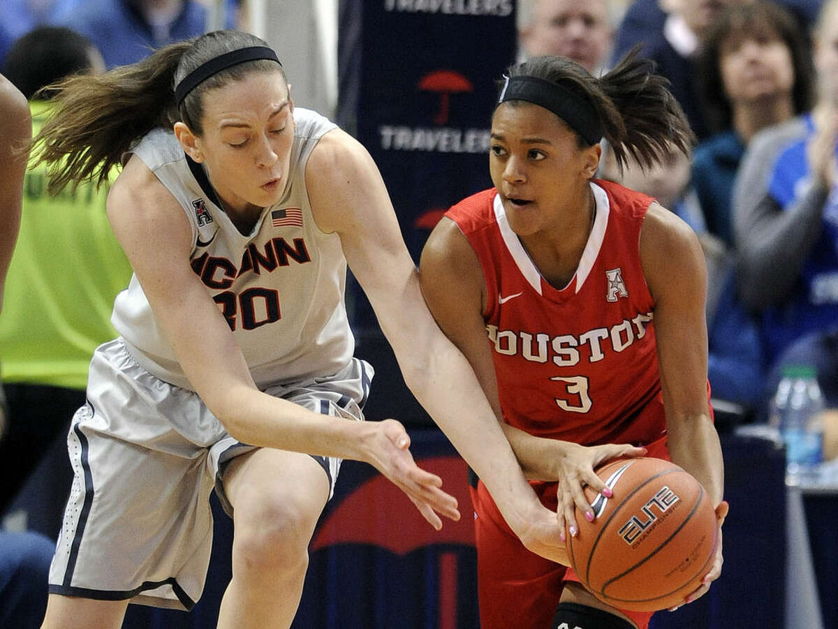 Connecticut's Breanna Stewart (30) and Houston's Bianca Winslow (3) fight for a loose ball during the first half of an NCAA college basketball game in Hartford, Conn., on Tuesday, Feb. 17, 2015. Stewart scored a game-high 26 points in Connecticut's 85-26 victory. (AP Photo/Fred Beckham)