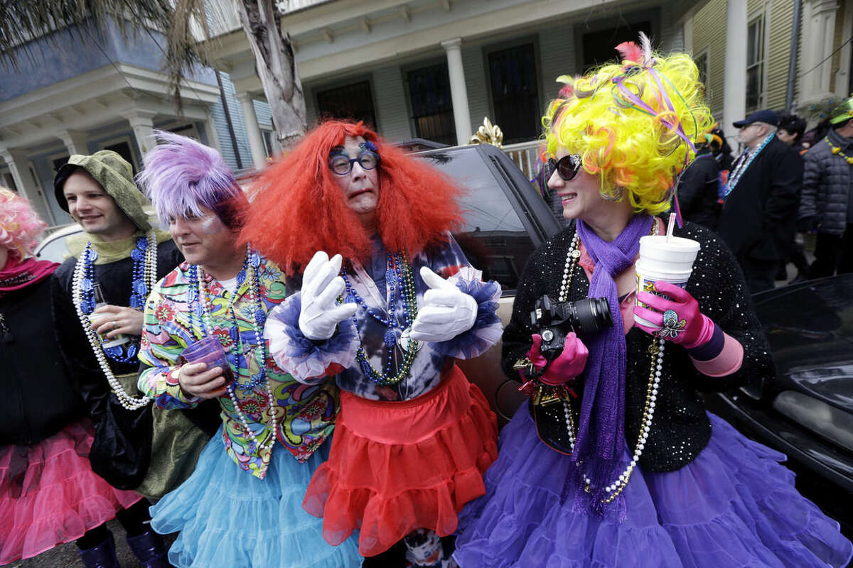 Revelers in costume participate in morning festivities along the route of the Society of Saint Anne parade on Mardi Gras in New Orleans, Tuesday, Feb. 17, 2015. Revelers in glitzy costumes filled the streets of New Orleans for the annual fat Tuesday bash, opening a day of partying, parades and good-natured jostling for beads and trinkets tossed from passing floats. (AP Photo/Gerald Herbert)