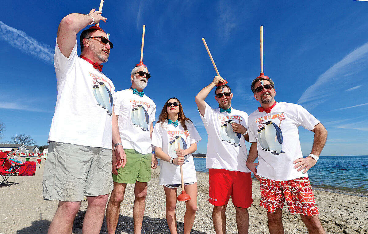 Hour photo / Erik Trautmann Peguin Plungers; Peter Bachmann, Ryan Goldberg, Andrew Graham, Rachel Bliden and Phil Goldberg get ready for the 2016 Westport Penguin Plunge at Compo Beach Saturday to benefit The Special Olympics.