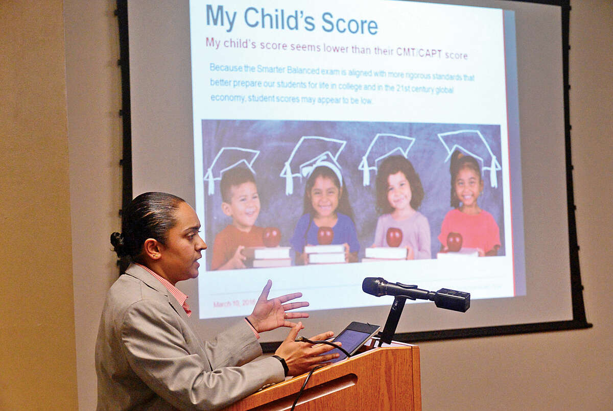 Hour photo / Erik Trautmann Yamuna Menon, Director of Research and Policy for ConnCAN discusses the benefit of K-12 assessments with a focus on SBAC and SAT and how CT results compare to national results. The program was for parents who wish to understand SBAC and individual student testing at the South Norwalk Library Branch Thursday evening.