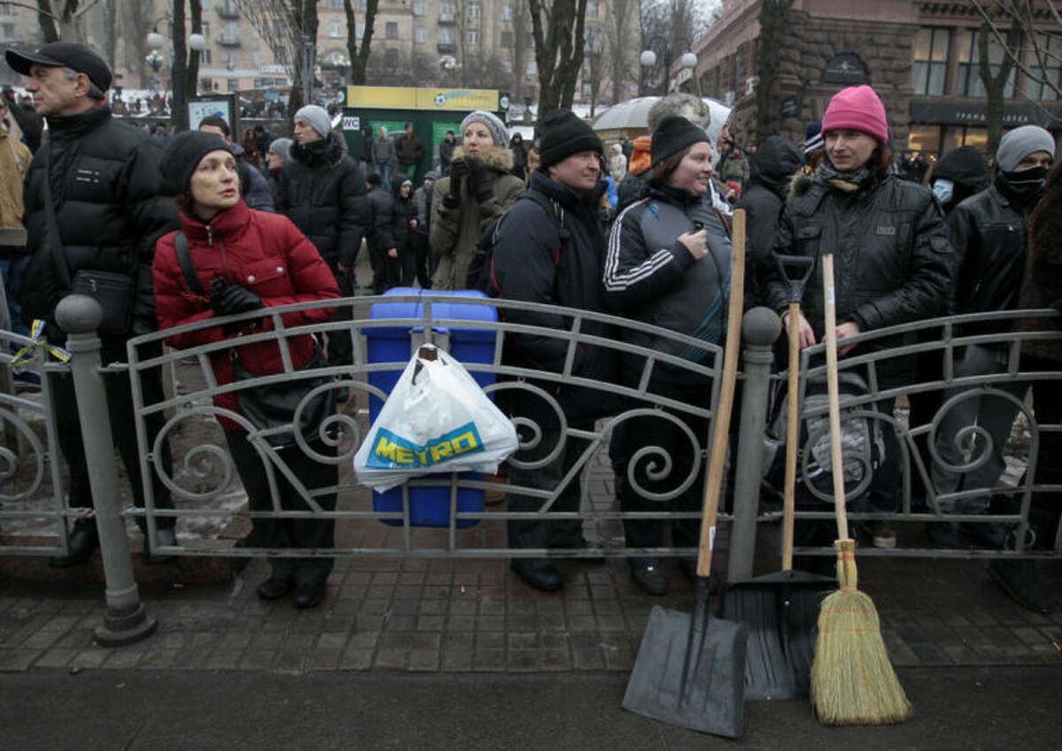 Demonstrators angered by more than two months of anti-government protests in Kiev gather on Khreschatyk street in Kiev, Ukraine, Saturday, Feb. 8, 2014. Thousands of people angered by months of anti-government protests in the Ukrainian capital converged on one of the protesters' barricades Saturday, but retreated after meeting sizeable resistance. (AP Photo/Sergei Chuzavkov)