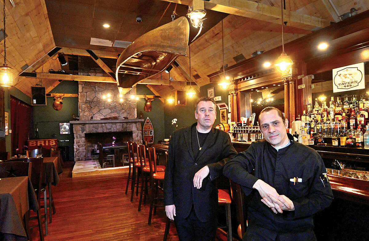 Owner Eric Monte and chef Remis Saget sit at the bar at Tavern 489, Glenbrook’s newest restaurant. 