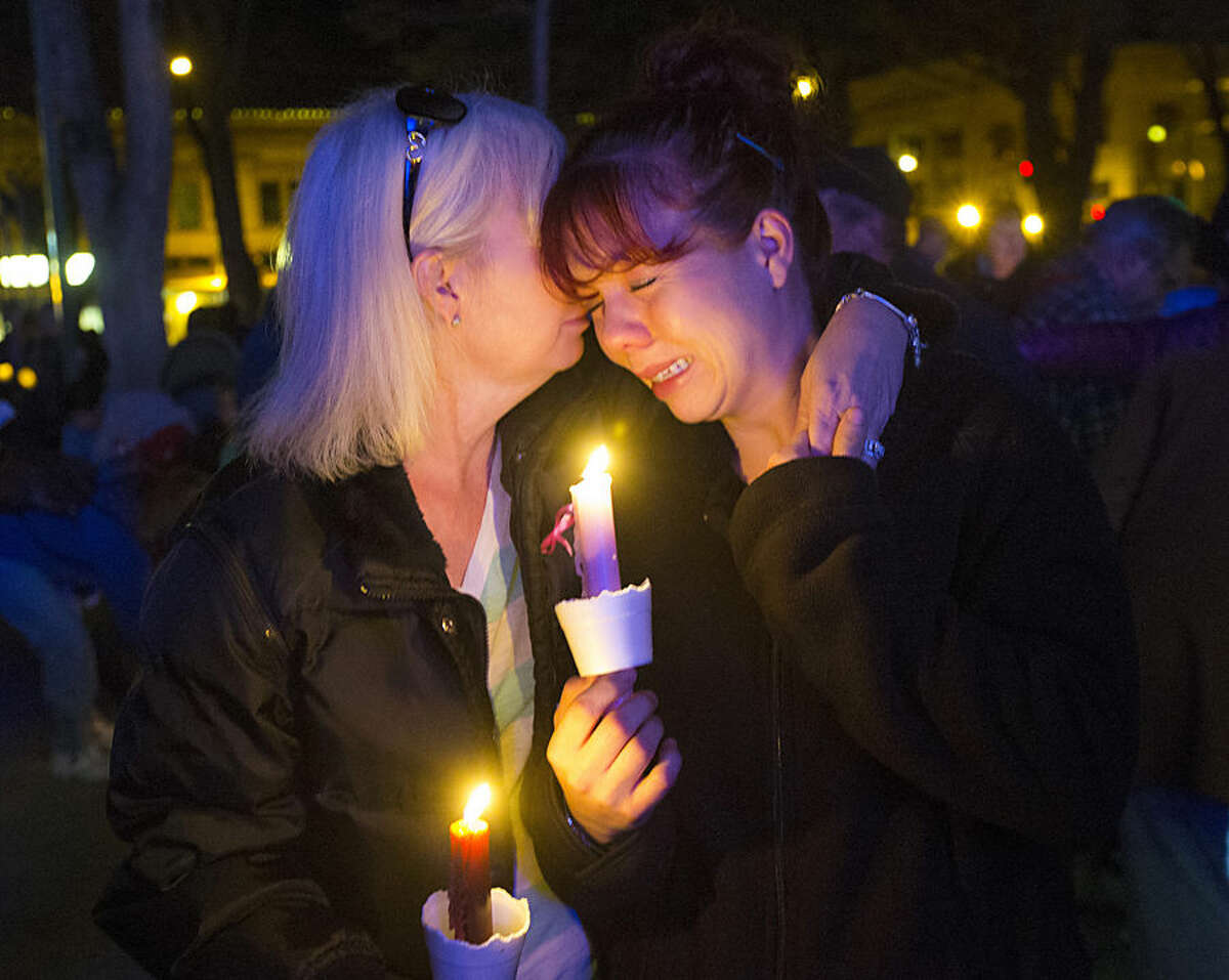 Tonya Castillo, left, comforts her daughter Tiffany Reid during a candlelight memorial for Kayla Mueller in Prescott, Ariz., Wednesday, Feb. 18, 2015. Kayla Mueller's death earlier this month was confirmed by her family and U.S. officials. The 26-year-old international aid worker from Prescott had been captured in Syria in August 2013. (AP Photo/The Arizona Republic, Michael Chow)