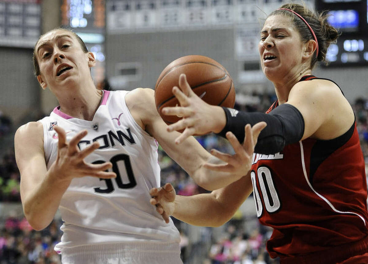 Connecticut's Breanna Stewart, left, and Louisville's Sara Hammond, right, reach for a loose ball during the first half of an NCAA college basketball game on Sunday, Feb. 9, 2014, in Storrs, Conn. (AP Photo/Jessica Hill)